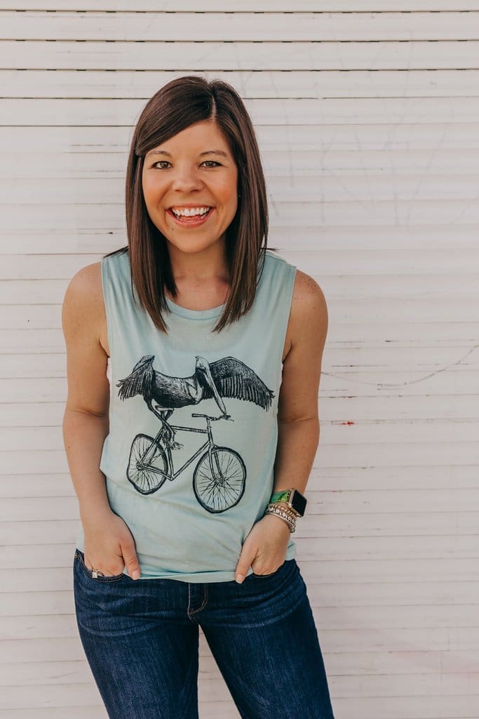 tampa blogger gentry adams wearing a green screen printed tank top with a pelican riding a bicycle
