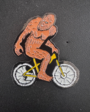 Sasquatch on a Bike Enamel Pin